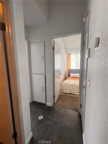 Hallway to bedrooms with closet storage