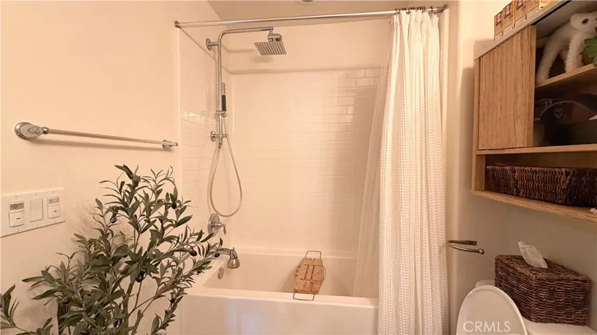 Primary bathroom vanity with natural wood cabinetry, Kohler fixtures, 11908 Nixon Lane Whittier CA
