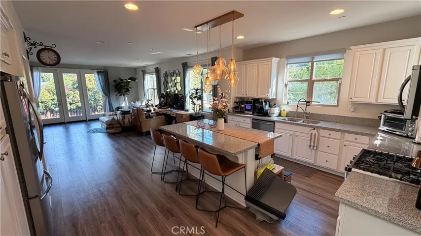 Kitchen and dining area open concept, warm wood flooring, 11908 Nixon Lane Whittier CA 90601
