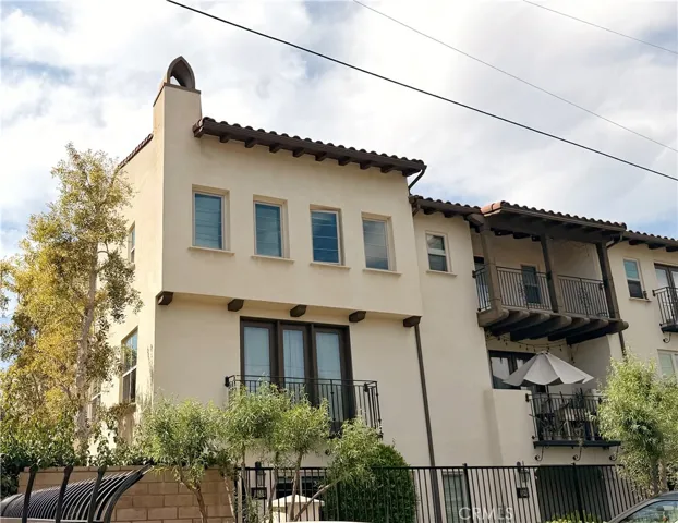 Front exterior with Spanish-inspired architecture and landscaping, Whittier CA townhome for sale
