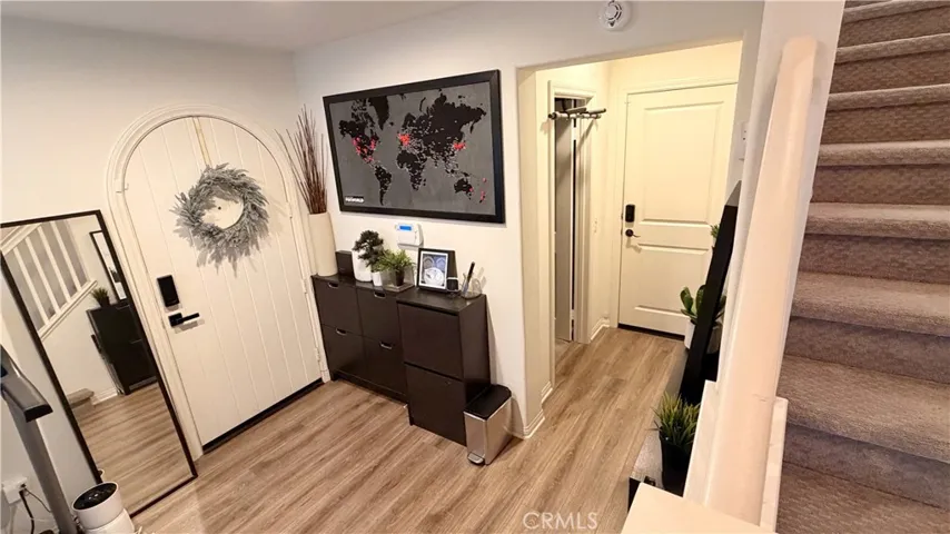 Living room with statement artwork wall and wood flooring, no Mello-Roos townhome Whittier CA
