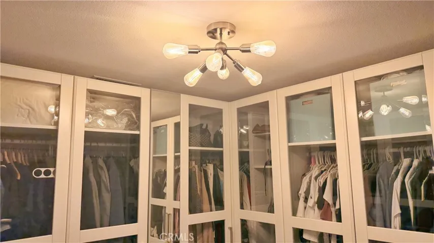 Bedroom currently configured as walk-in closet with custom built-ins, 11908 Nixon Lane Whittier
