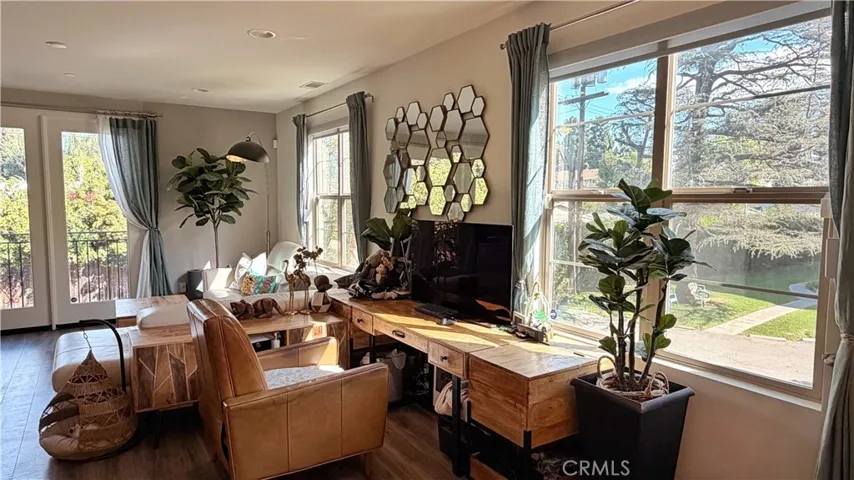 Living and dining area with large windows and designer light fixtures, 11908 Nixon Lane Whittier
