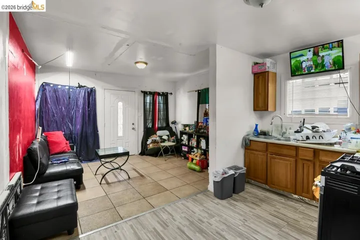 Kitchen featuring wood finish cabinets, range with gas stovetop, light countertops, and light wood-style flooring