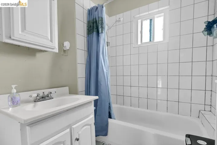 Full bath featuring vanity and shower / bath combo