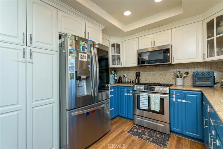 Upgraded two tone kitchen with lots of custom cabinetry including a great pantry, granite countertops and 
 complimentary colored tiled backsplash.