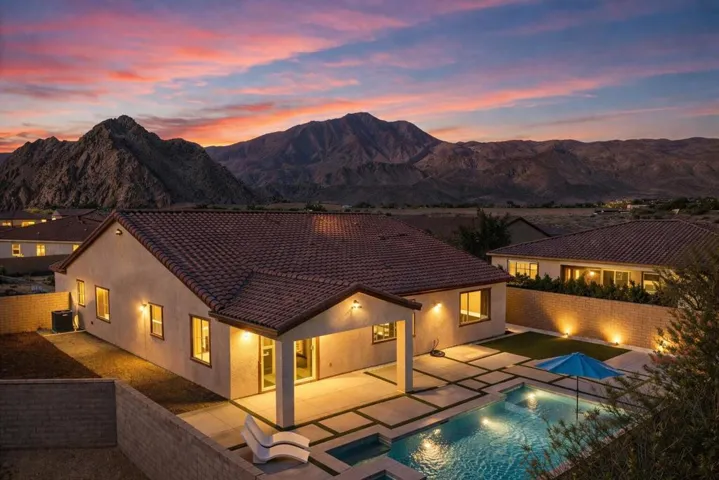 Twilight desert home with pool view