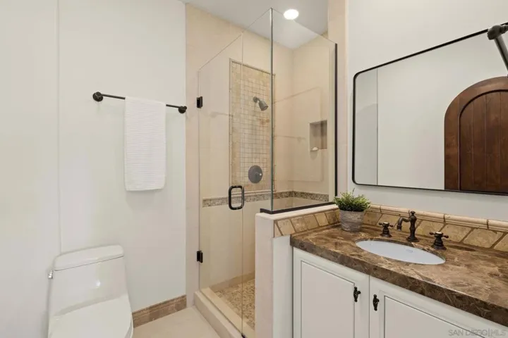 Guest en suite bathroom with a walk-in shower, offering a clean, comfortable space designed for ease and privacy.