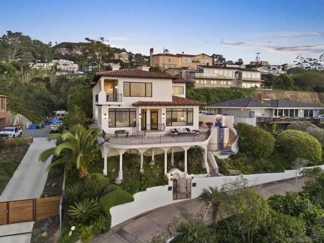 Elevated hillside residence with panoramic ocean views, where layered terraces, lush landscaping, and warm architecture create a private coastal retreat defined by light, air, and a seamless connection to the La Jolla horizon.