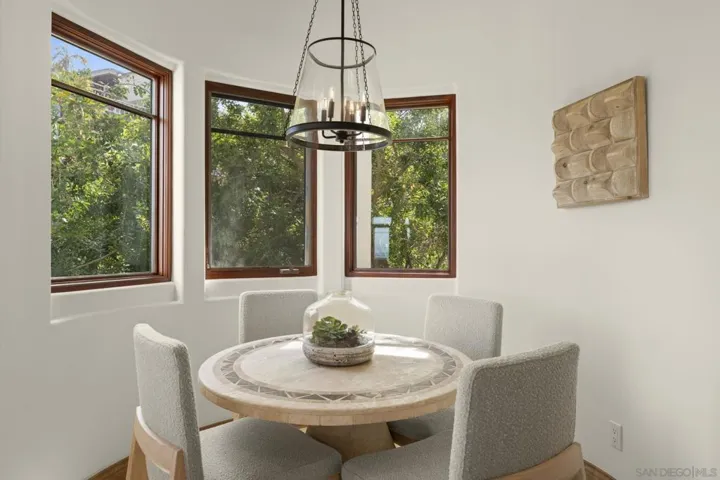 Eat-in kitchen area filled with natural light, where sunlit mornings and soft finishes create an inviting space for everyday dining.