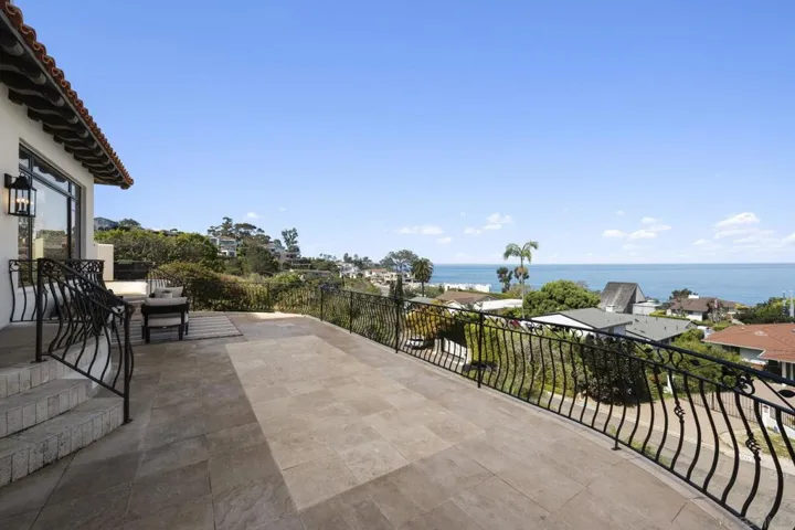 Spacious balcony just off the living areas, offering panoramic views of the ocean and coastline, an effortless extension of indoor living into the open coastal air.