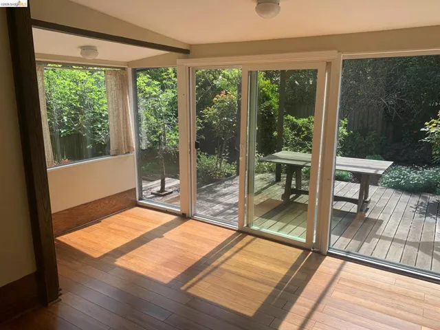 Entryway featuring hardwood / wood-style floors, lofted ceiling, and healthy amount of natural light