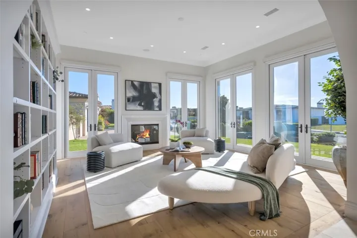 Formal Living Room with Fireplace, Library Book Case and 4 sets of French Doors