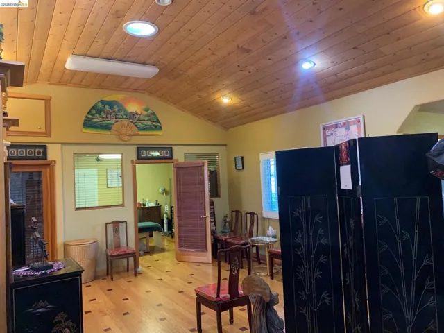 Sitting room with a vaulted wooden ceiling, recessed lighting, and light wood-style floors