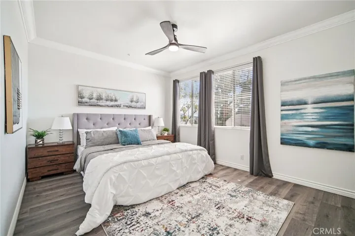 Spacious primary bedroom with ample natural light, perfect for relaxation and rest.