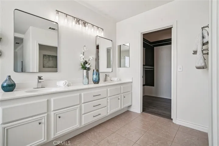 Dual sinks with new mirrors and light fixture.