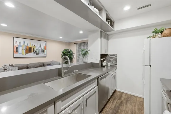 Upper cabinets have been replaced with shelving that gives a more spacious feel to the kitchen.  Shelf is useful and versatile.