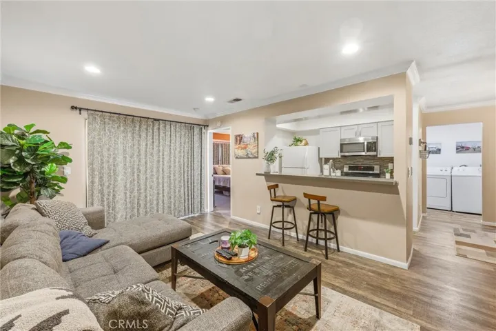 This remodeled condo has upgraded flooring, upgraded kitchen cabinets. Bar area has been modified for more kitchen visibility.
