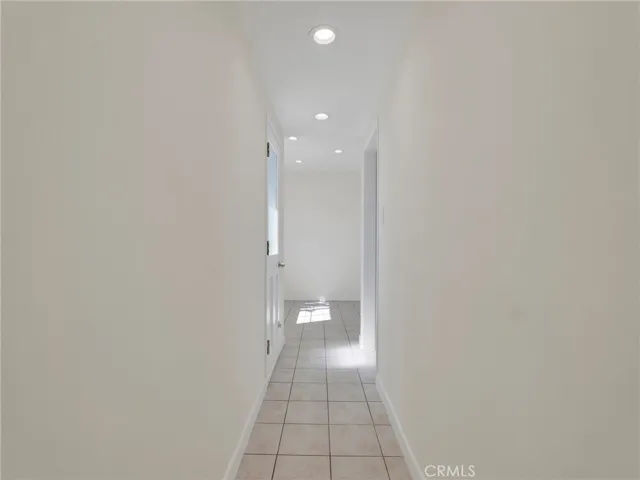 Hallway From Family Room To Kitchen, With Door To Laundry Room & 3/4 Bath, And Exterior Door