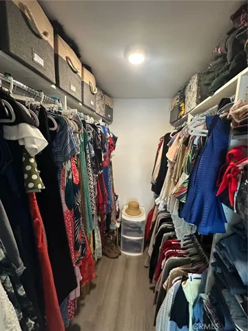 Walk in closet with organized shelving from closet​​‌​​​​‌​​‌‌​​‌​​​‌‌​​​‌​​‌‌​​‌‌​​‌‌​​​​ world.