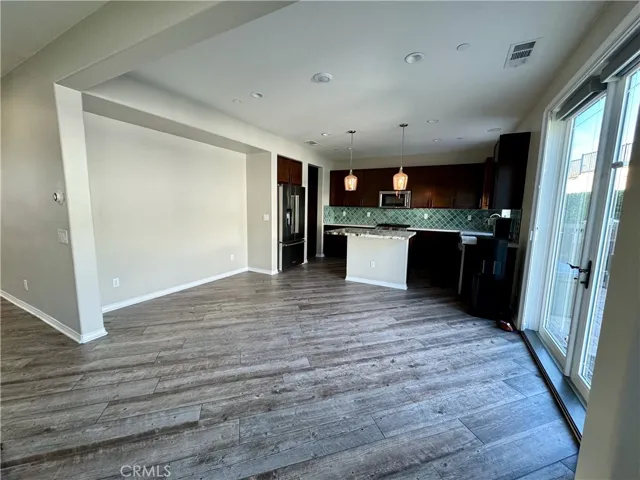 The open floorplan allows you to cook and entertain.  Here is a photo of the dining room and kitchen.