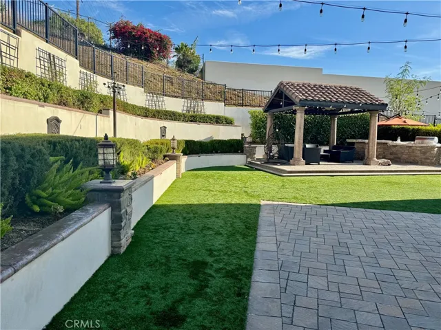 The backyard is equally gorgeous at night with its automatic light pillars and smart Italian lights.  Did someone say barbecue and an outdoor movie?
