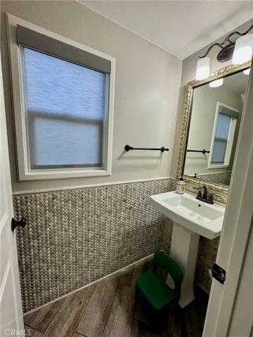 The guest bathroom is elegantly appointed with marble wainscoating and Kohler fictures.