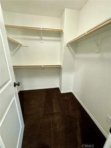 Primary bedroom suite comes with an airy walk-in closet with space to hang all of your clothes.  Please note, we are not responsible for fights as to who gets this closet and who gets the standard sliding door closet included in the primary suite.