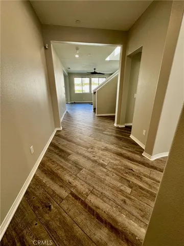 Long entryway has immediate wow factor with diagonally installed wood-plank tiles.  The wood-plank tiles are beautiful, great for pets, and easy to maintain.