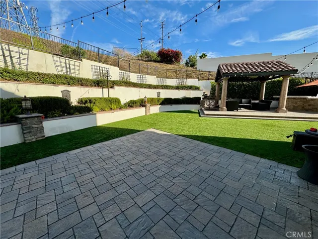 This is what we call an entertainer's backyard!  Enjoy the two large patios, one is covered and has full outdoor kitchen.