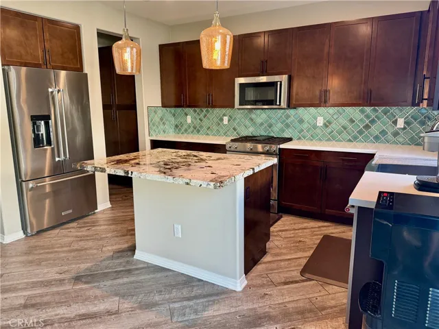 The beautiful kitchen features all Kitchen Aid appliances that include a refrigerator, five burner stove, convection oven, convection microwave, and dishwasher, in addition to the farmhouse stainless steel sink that overlooks the manicured backyard.  The kitchen also comes with a pantry, Brazilian granite island, and tons of storage for all your cooking needs.