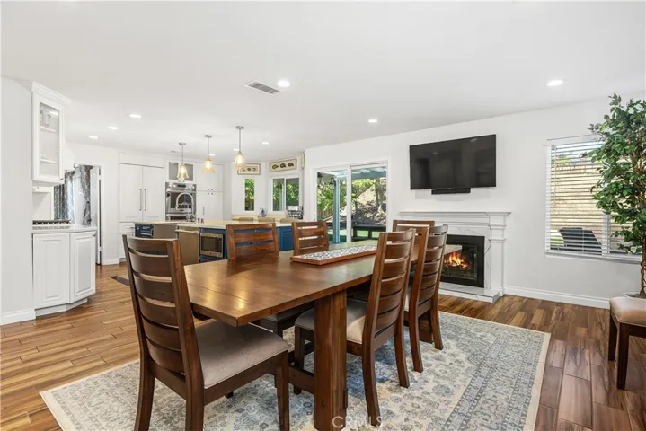 Fireplace in family room currently used as dining space: Digitally altered fire in fire place