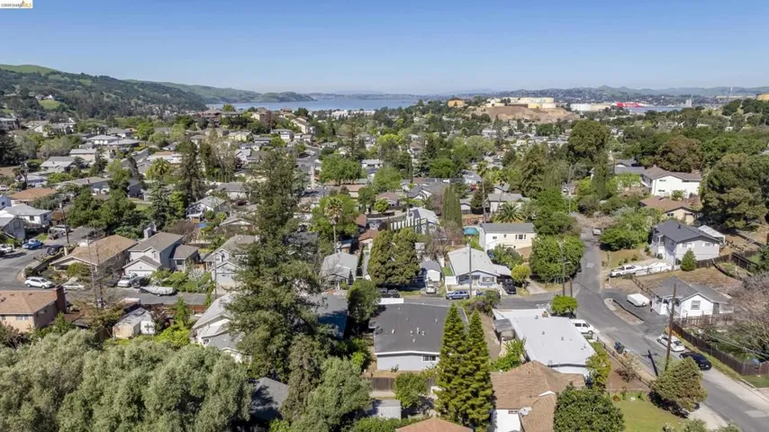 Aerial perspective of suburban area with a water and mountain view