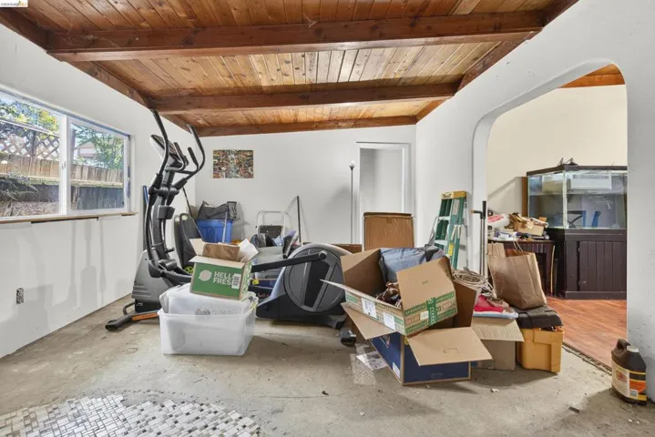 Interior space with wood ceiling, arched walkways, and vaulted ceiling with beams
