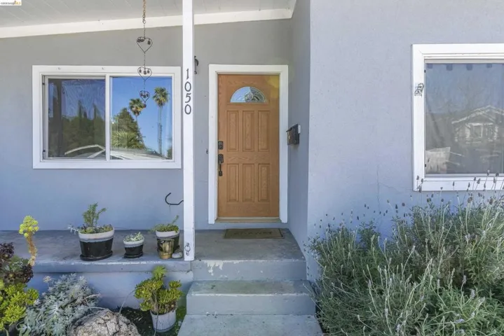 View of exterior entry featuring stucco siding
