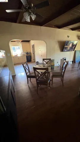 Exposed beam ceiling with wood-finish flooring