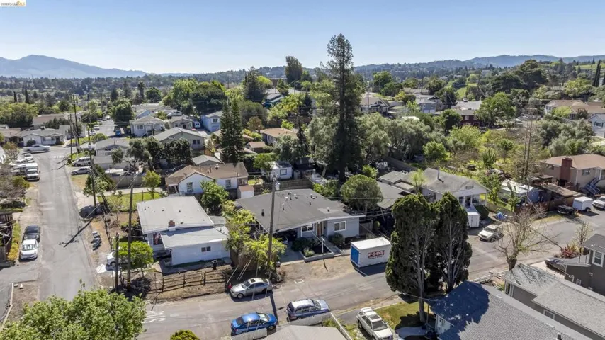 Aerial perspective of suburban area featuring a mountain backdrop
