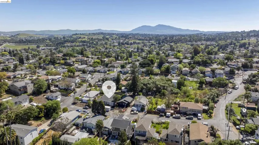 Aerial view of residential area featuring a mountainous background