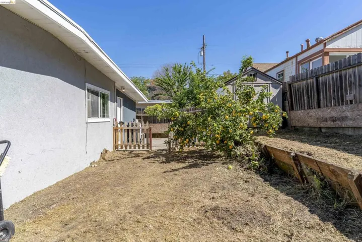 Fenced backyard featuring a storage shed