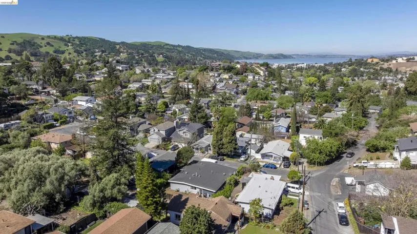 Aerial perspective of suburban area with a mountainous background