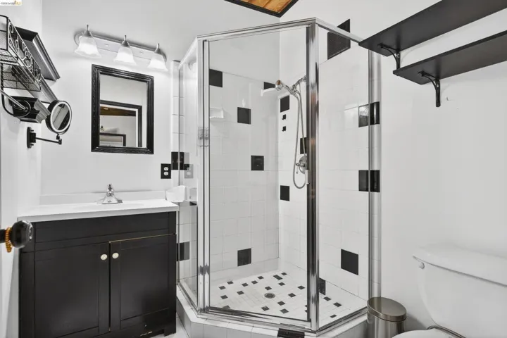 Full bathroom with vanity and a stall shower