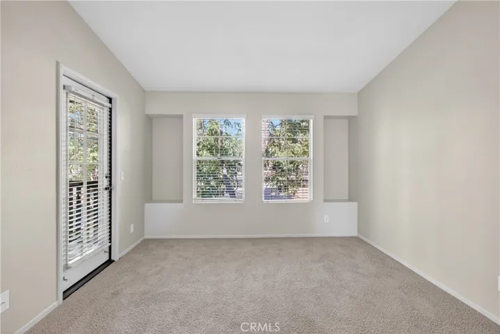 Door leads to L-shaped balcony, which also has a door that leads to the living room on the opposite side.