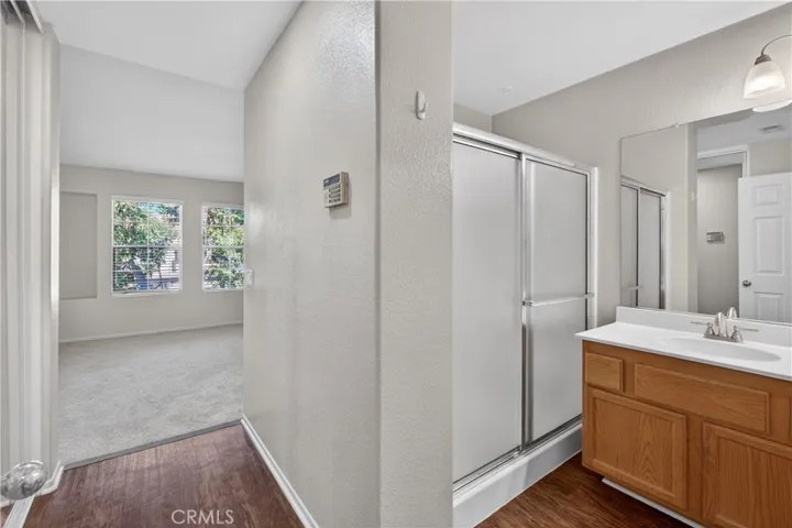 View of master bedroom and corresponding bathroom.