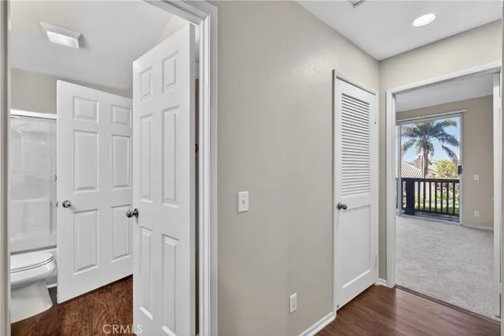 Hallway that leads to bathroom, laundry, and bedroom