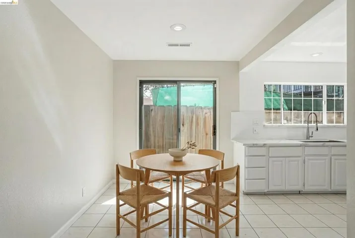 Dining space featuring light tile patterned floors and baseboards