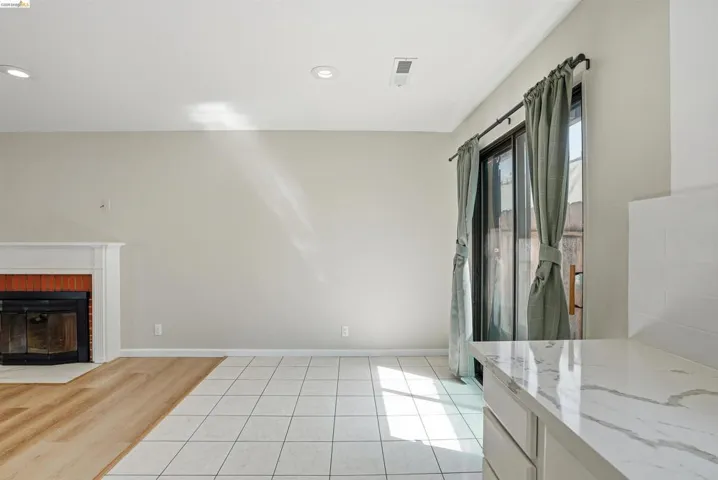 Unfurnished living room featuring light tile patterned floors, a fireplace, and recessed lighting
