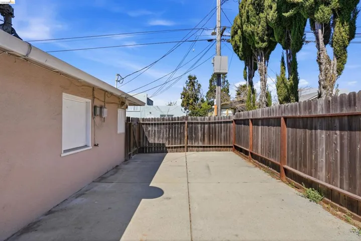 Fenced backyard with a patio