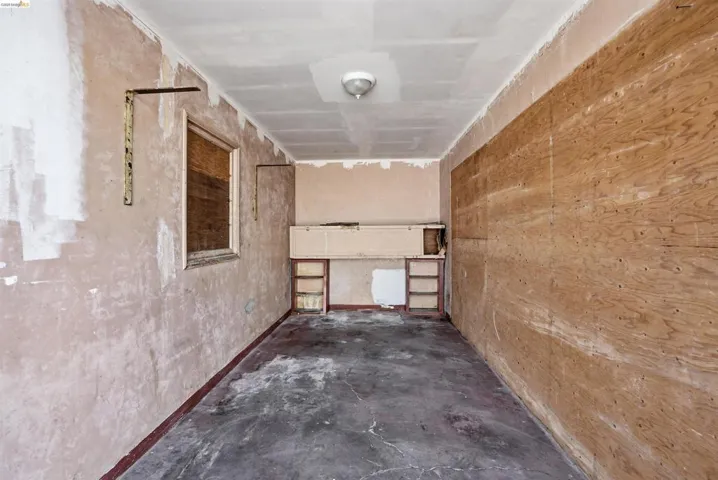Hall with unfinished concrete flooring