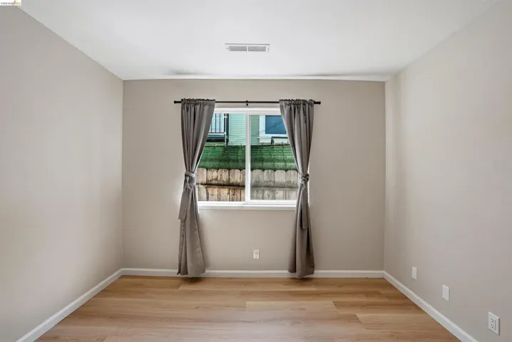 Spare room with light wood finished floors and baseboards