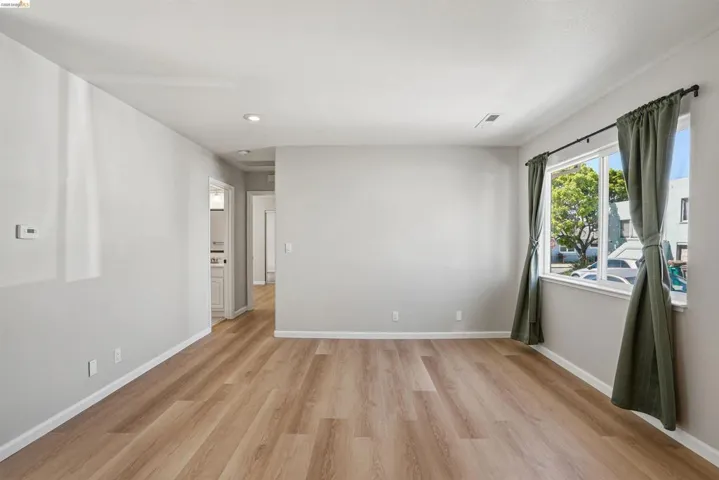 Empty room featuring light wood finished floors and recessed lighting
